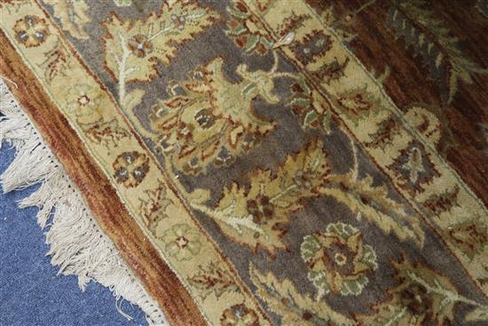 A Persian style tan ground carpet 306cm x 250cm